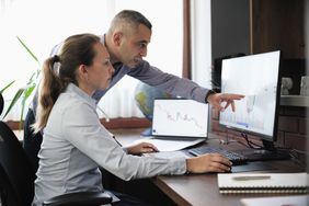Two at-home traders working together and using Bollinger bands to monitor for overbought levels.