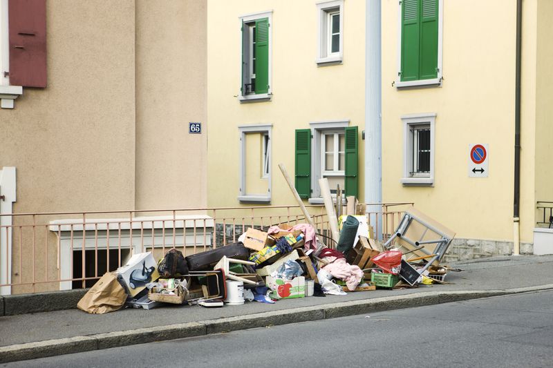 Belongings piled on sidewalk outside building