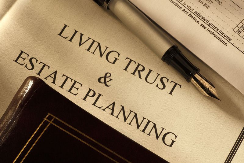 Close-up of fountain pen with living trust and estate planning documents