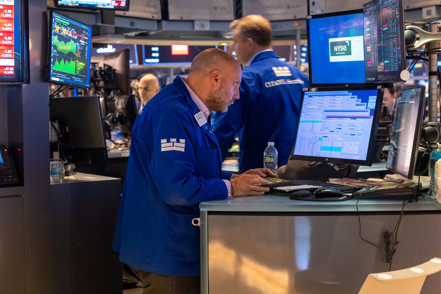 People walk on the floor of the New York Stock Exchange (NYSE).