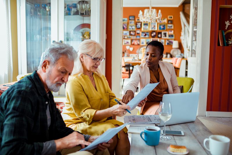 Couple meeting with professional paperwork computer home