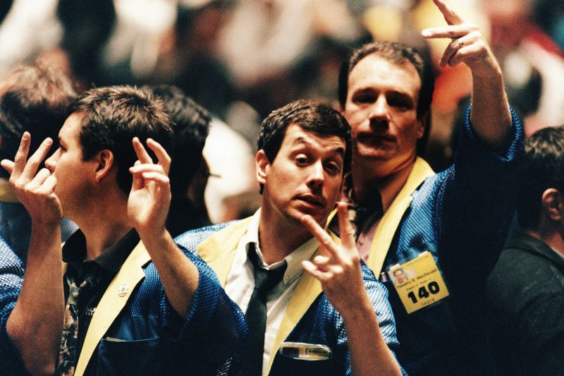 floor brokers gesturing on a trading floor