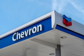 The word "Chevron" and the company's red and blue logo is on the roof of a gas station.
