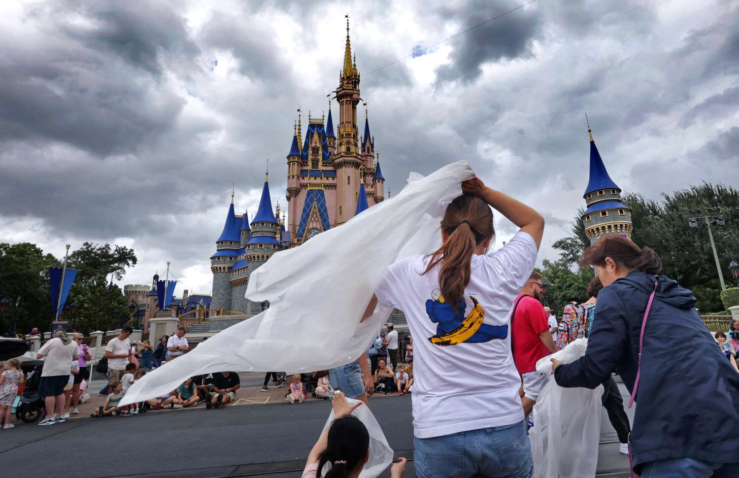 Guests at the Magic Kingdom break out ponchos at Cinderella Castle as bands of weather from Hurricane Helene move through Walt Disney World in Bay Lake, Florida, on Sept. 26, 2024