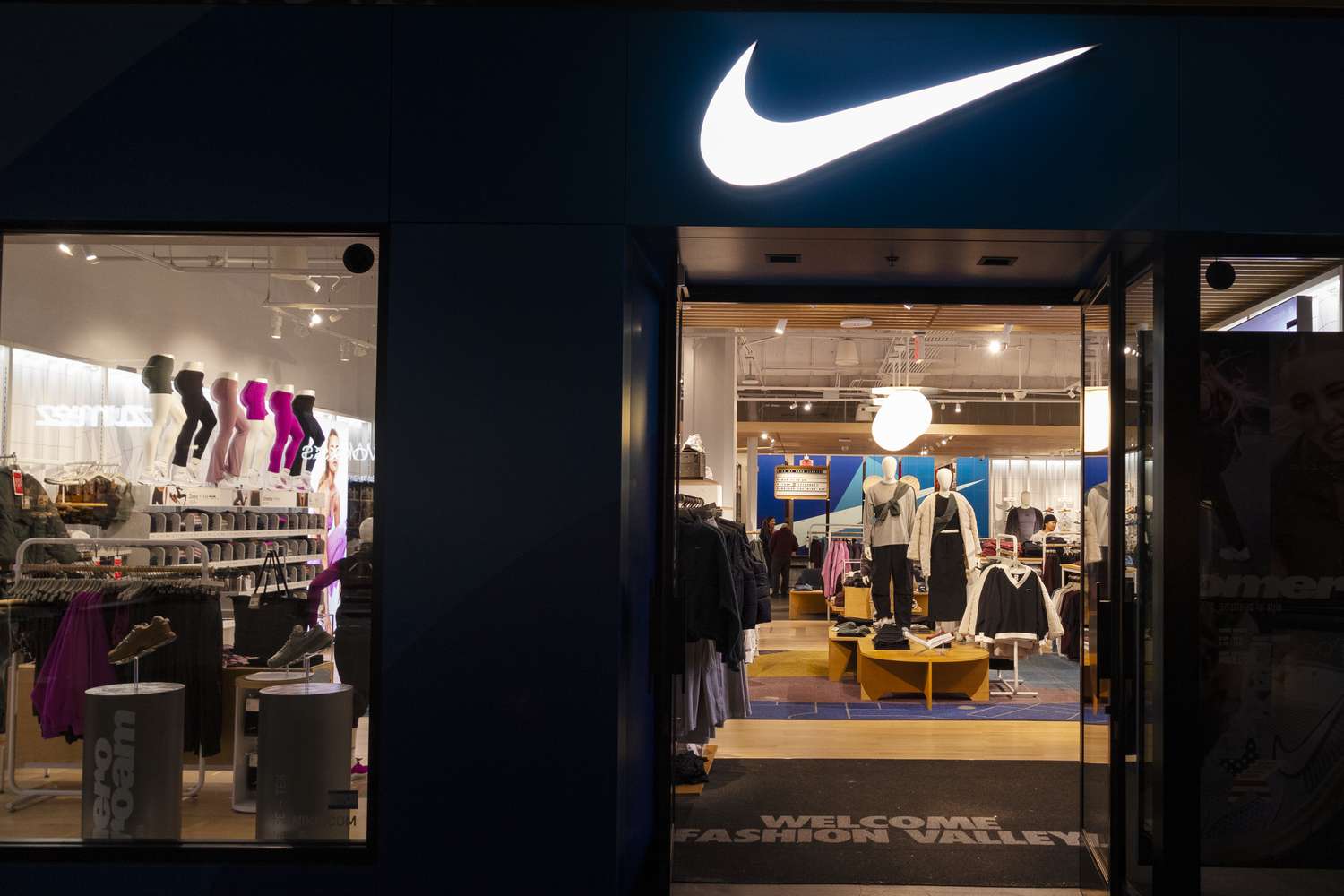 The Nike corporate logo hangs above their store at Fashion Valley in San Diego, California