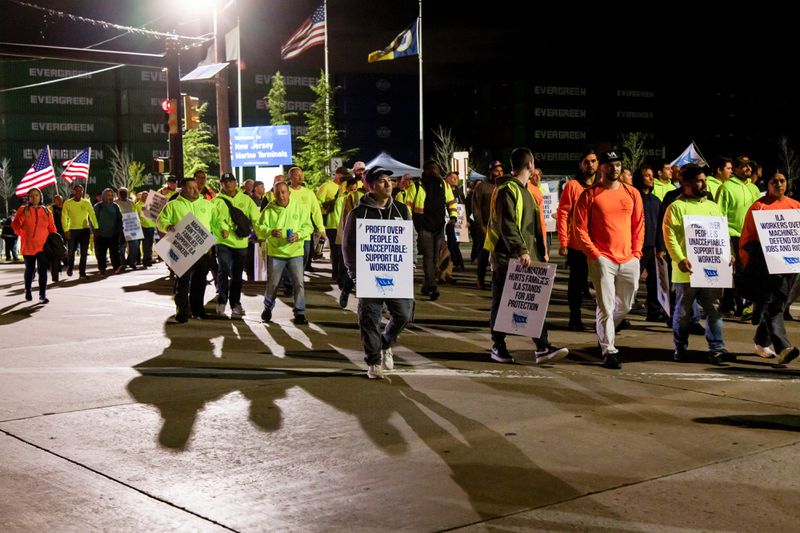 Workers picket outside the APM container terminal at the Port of Newark in Newark, New Jersey, US, on Tuesday, Oct. 1, 2024. 