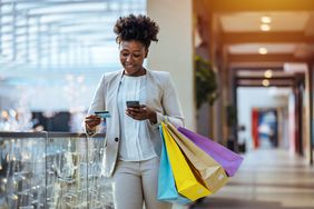 Woman Holds Shopping Bags in Mall