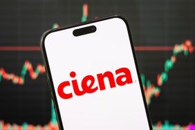The red Ciena logo is seen on a phone screen, with a stock chart in the background.