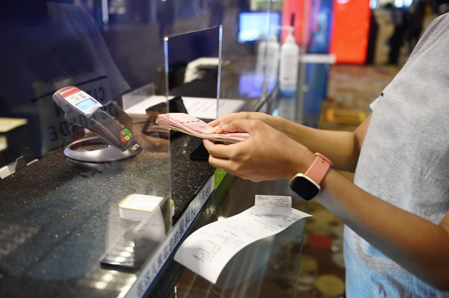 Currency exchange transaction at a counter.