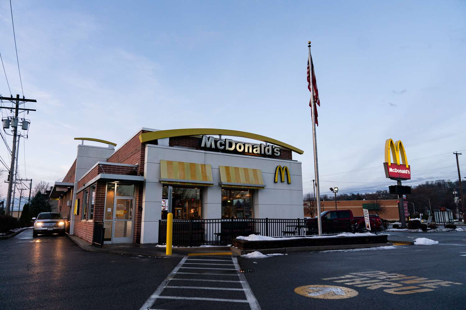 A car pulls up to a McDonald's drive-through window