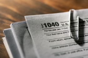 A close-up photograph of tax forms on a desk. 