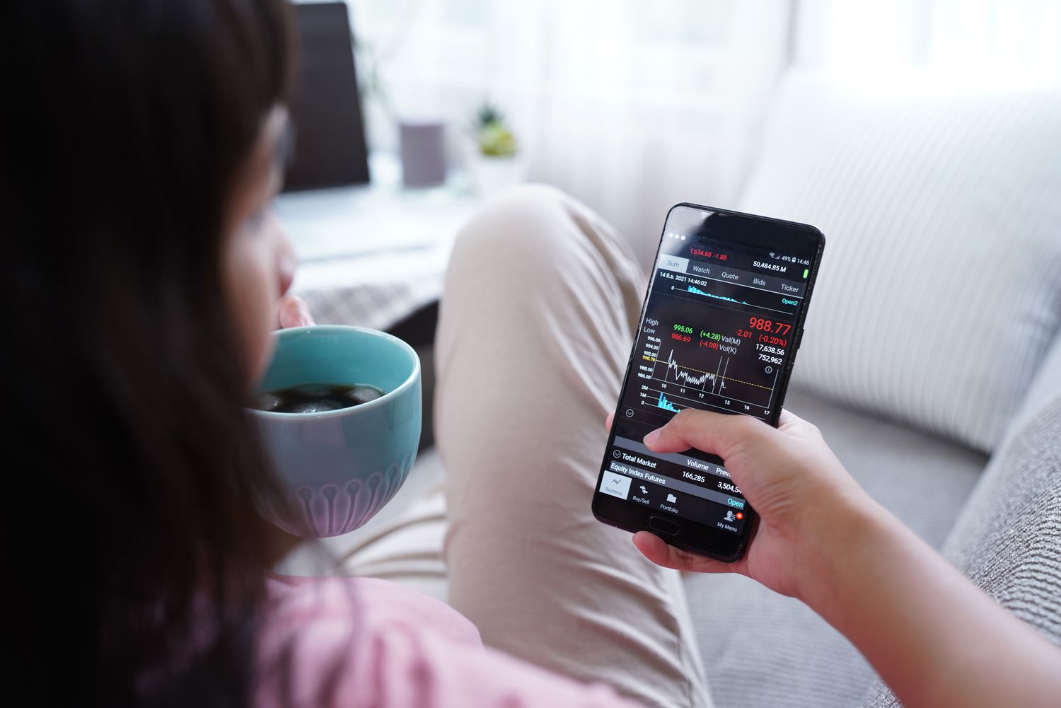 woman investing on smart phone