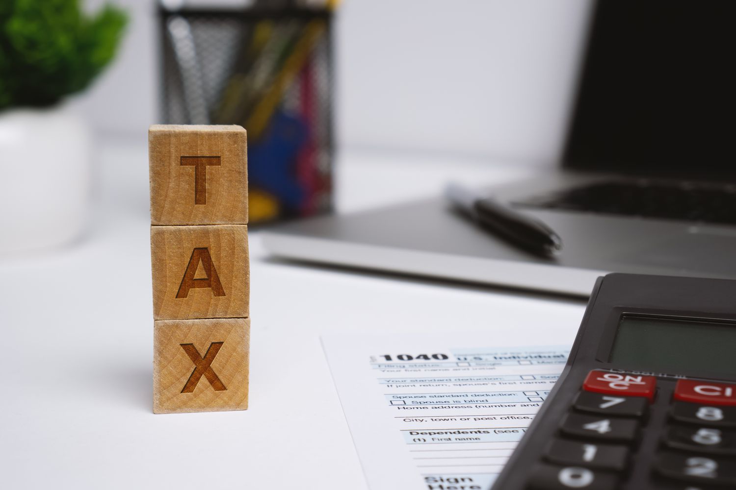 Three wood blocks spelling tax on tax forms