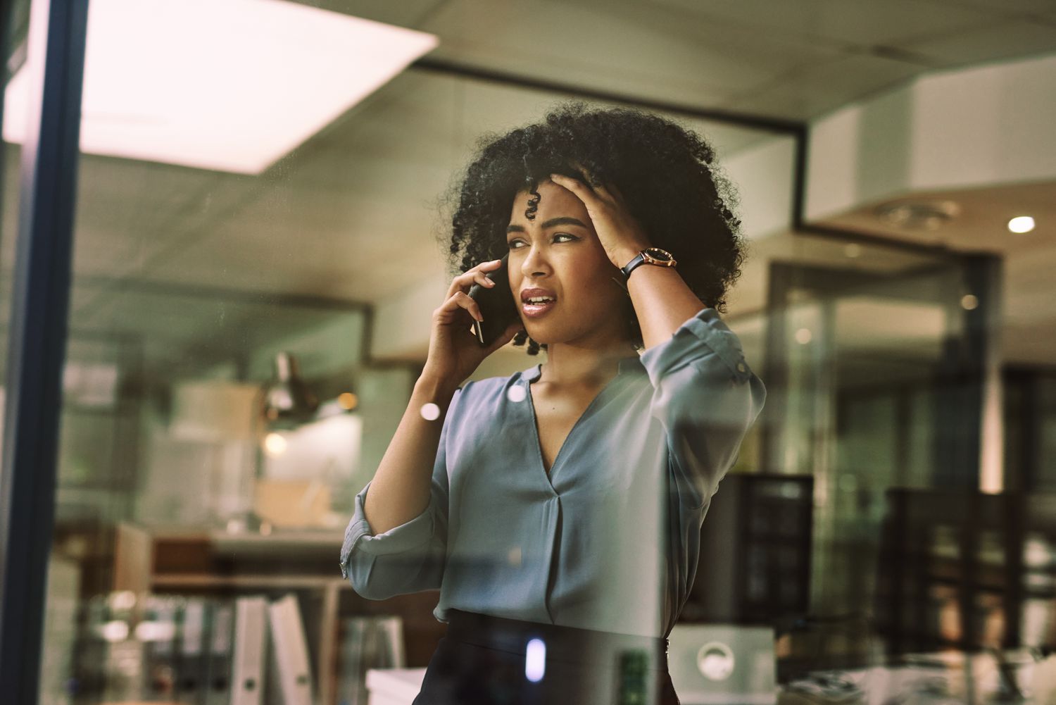 An upset woman talking on a phone