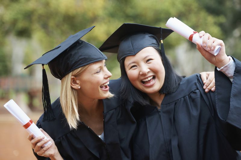 two female college graduates