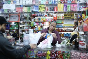 People buys items in a bodega in the Bronx borough of New York City on February 27, 2025. 