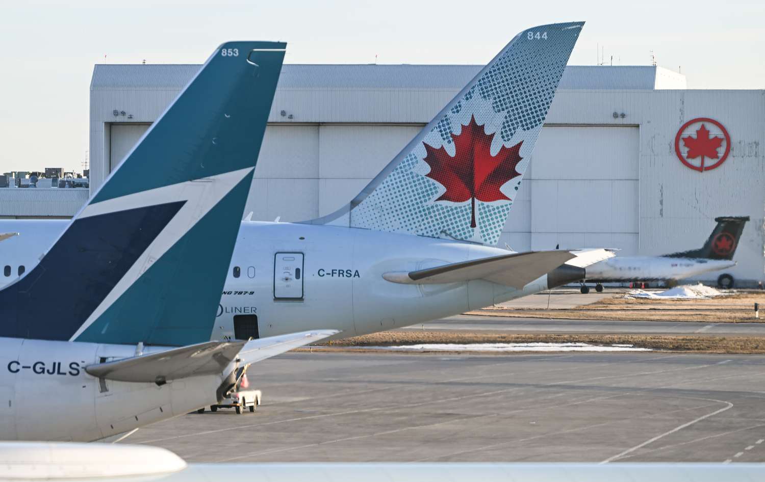 Air Canada and Westjet aircraft parked at Calgary International Airport