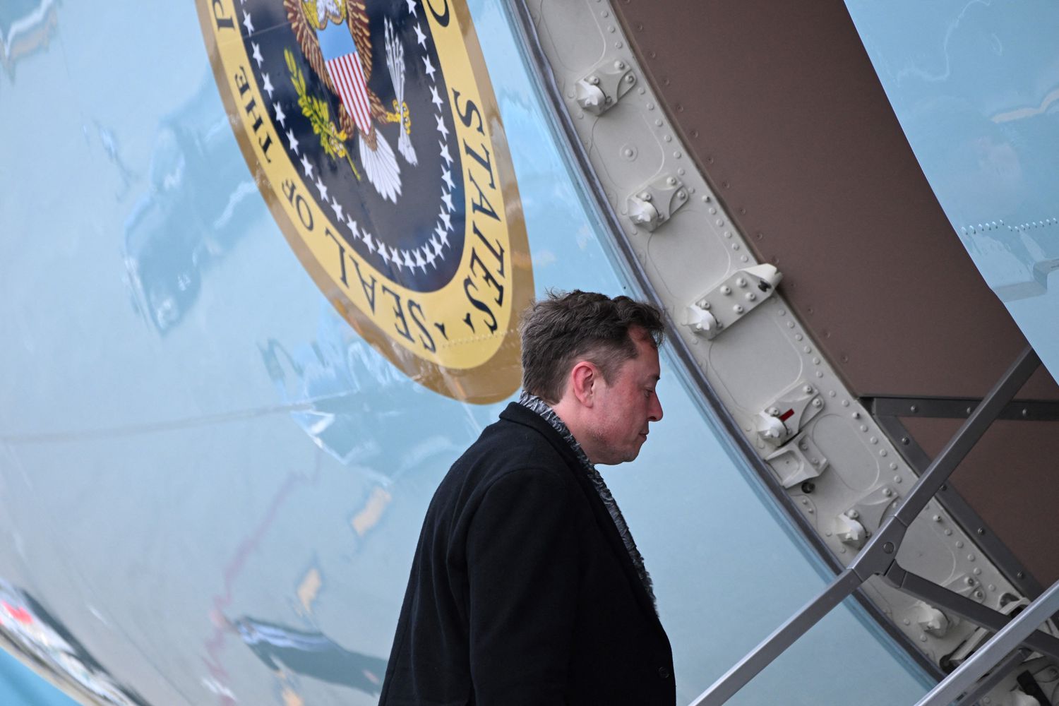 Elon Musk boards Air Force One at Palm Beach International Airport on Sunday. Musk was returning to Washington with President Trump.