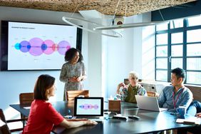 businesswoman heads meeting in board room