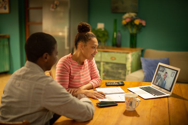 Couple talking with advisor online