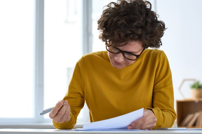 Woman signing a debt cancellation contract
