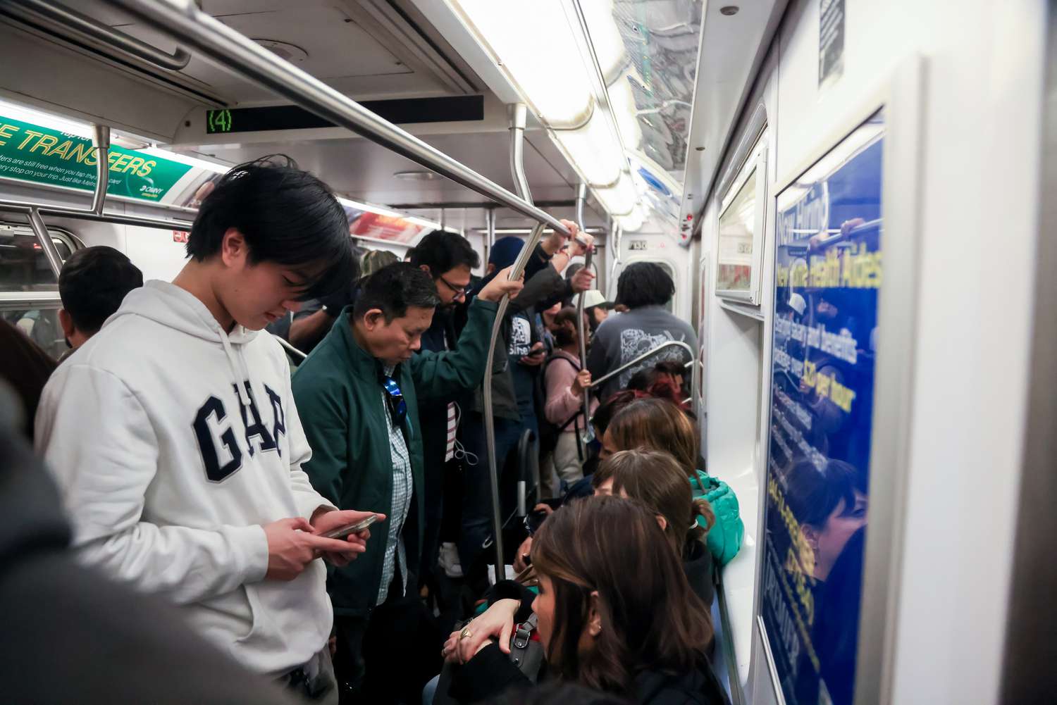 Commuters ride a 4 train in New York, US, on Wednesday, March 19, 2025.