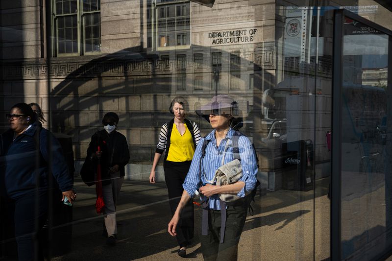 Commuters near the Smithsonian National Mall Metro Station outside the Department of Agriculture in Washington, DC, US, on Thursday, May 1, 2025.