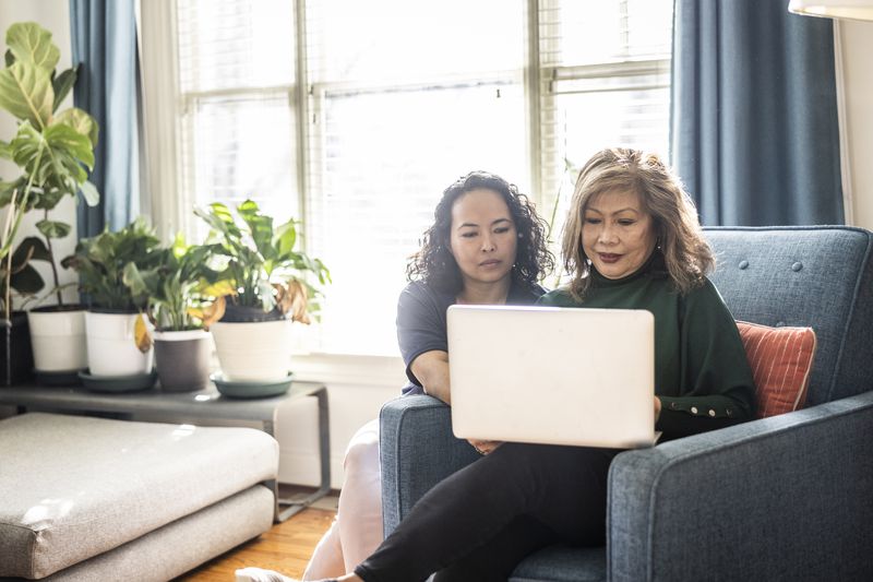 Two women looking at something on a laptop