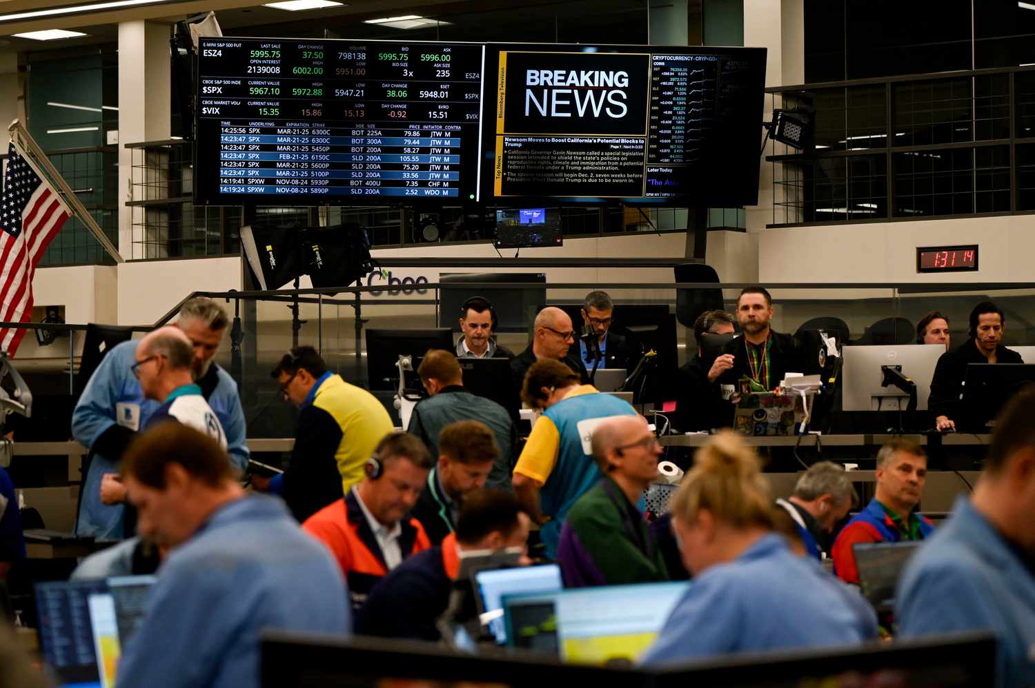 Stock information displayed as traders work in the S&P options pit at the Cboe Global Markets exchange in Chicago, Illinois, on Nov. 7, 2024