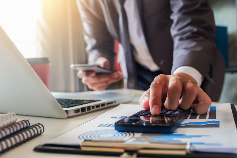 The Midsection of Businessman Working at Desk in Office