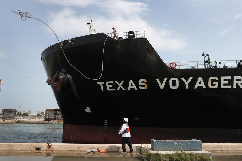 A line handler helps dock the oil tanker, Texas Voyager, as it pulls into its mooring to offload its crude oil.