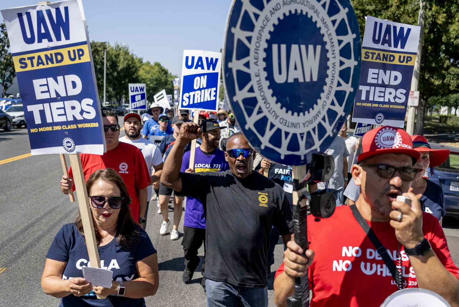 Striking United Auto Workers (UAW) march in front of the Stellantis Mopar facility on September 26, 2023.