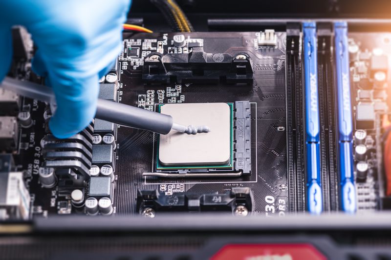 technician inserting chip into computer