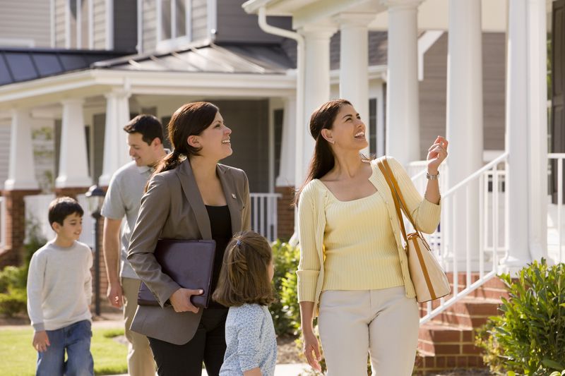 Relator Showing House to Young Family