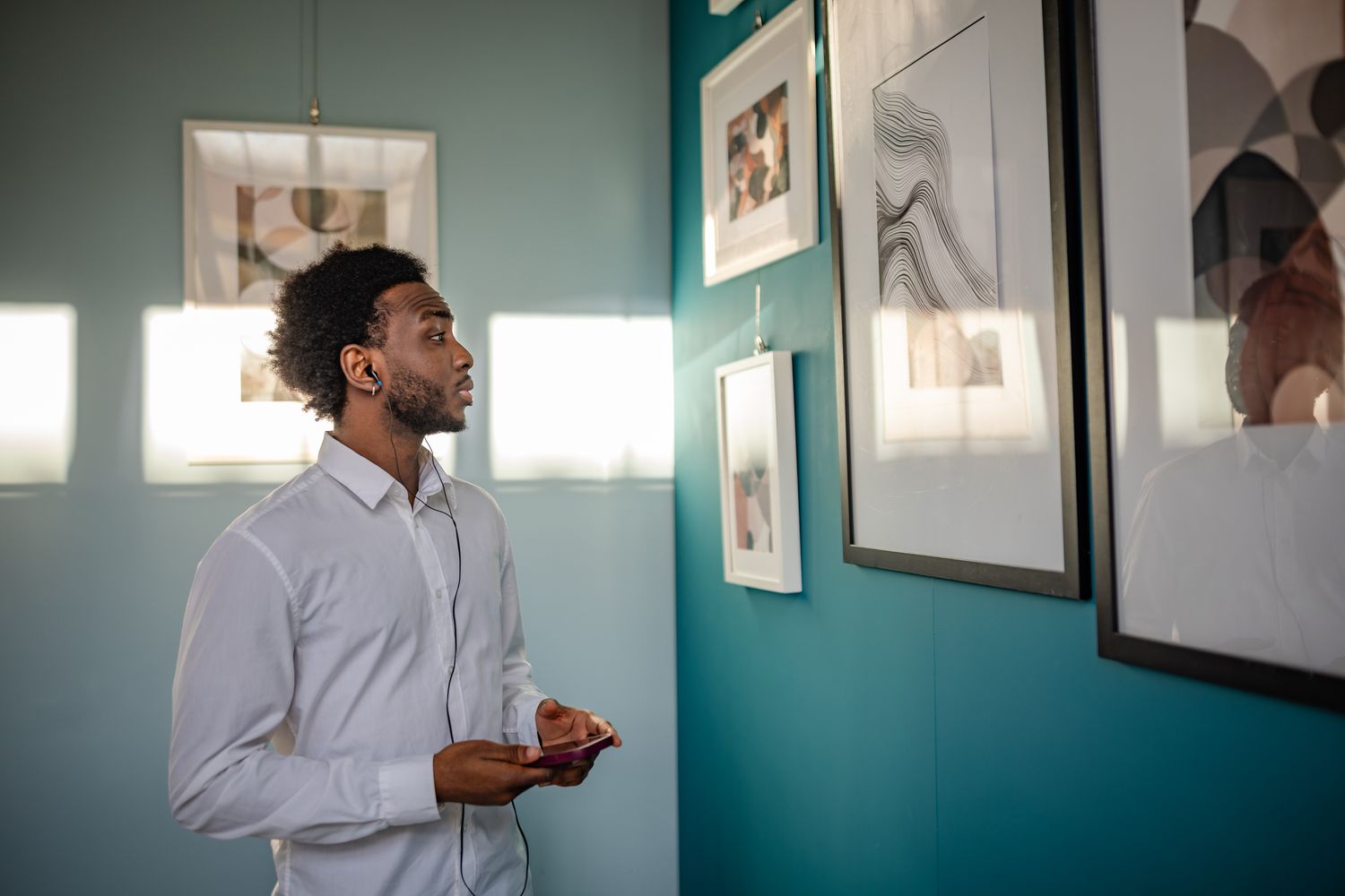 Person looking at a piece of art in a gallery.