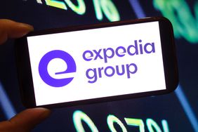 The purple Expedia Group logo on a phone screen in front of a black and green background
