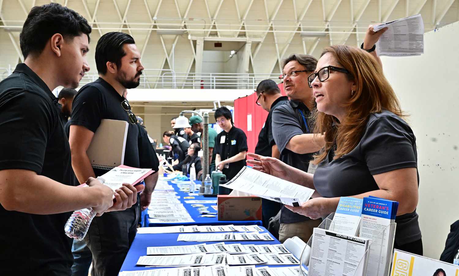 Job seekers speak with prospective employers during a City of Los Angeles career fair
