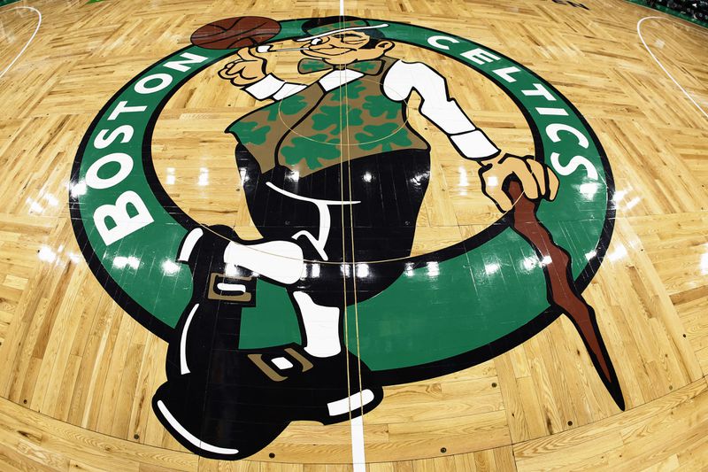 The Boston Celtics logo is seen on the hardwood floor of TD Garden.