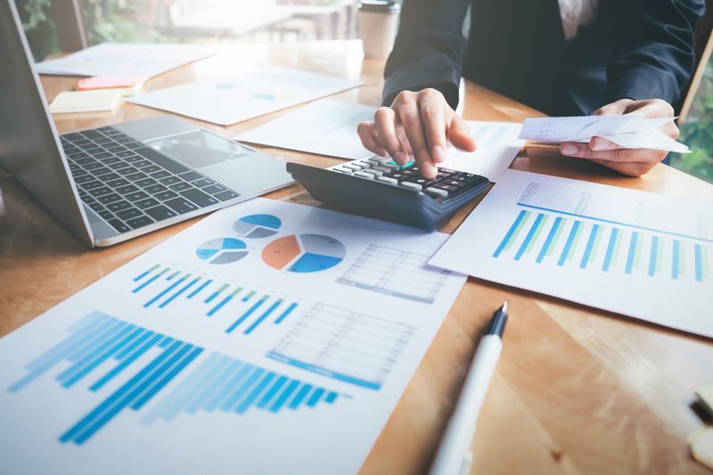 Businesswoman Reading Graphs on Table