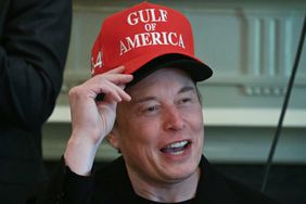 Tesla CEO Elon Musk speaks while wearing a black hat, with a red "Gulf of America" hat on top of it.