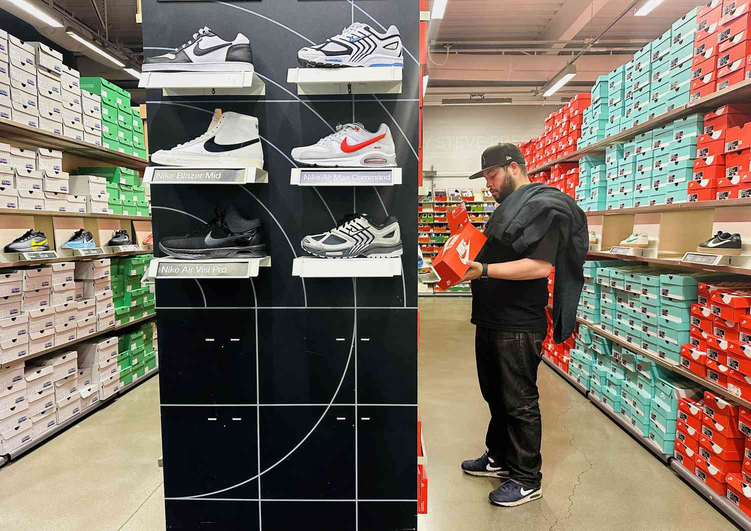 A man shops for shoes at a Nike outlet store in Los Angeles, California on April 10, 2025. Trump on April 9 announced a 90-day pause on the most onerous new tariffs on imports to the United States for every country except China. 