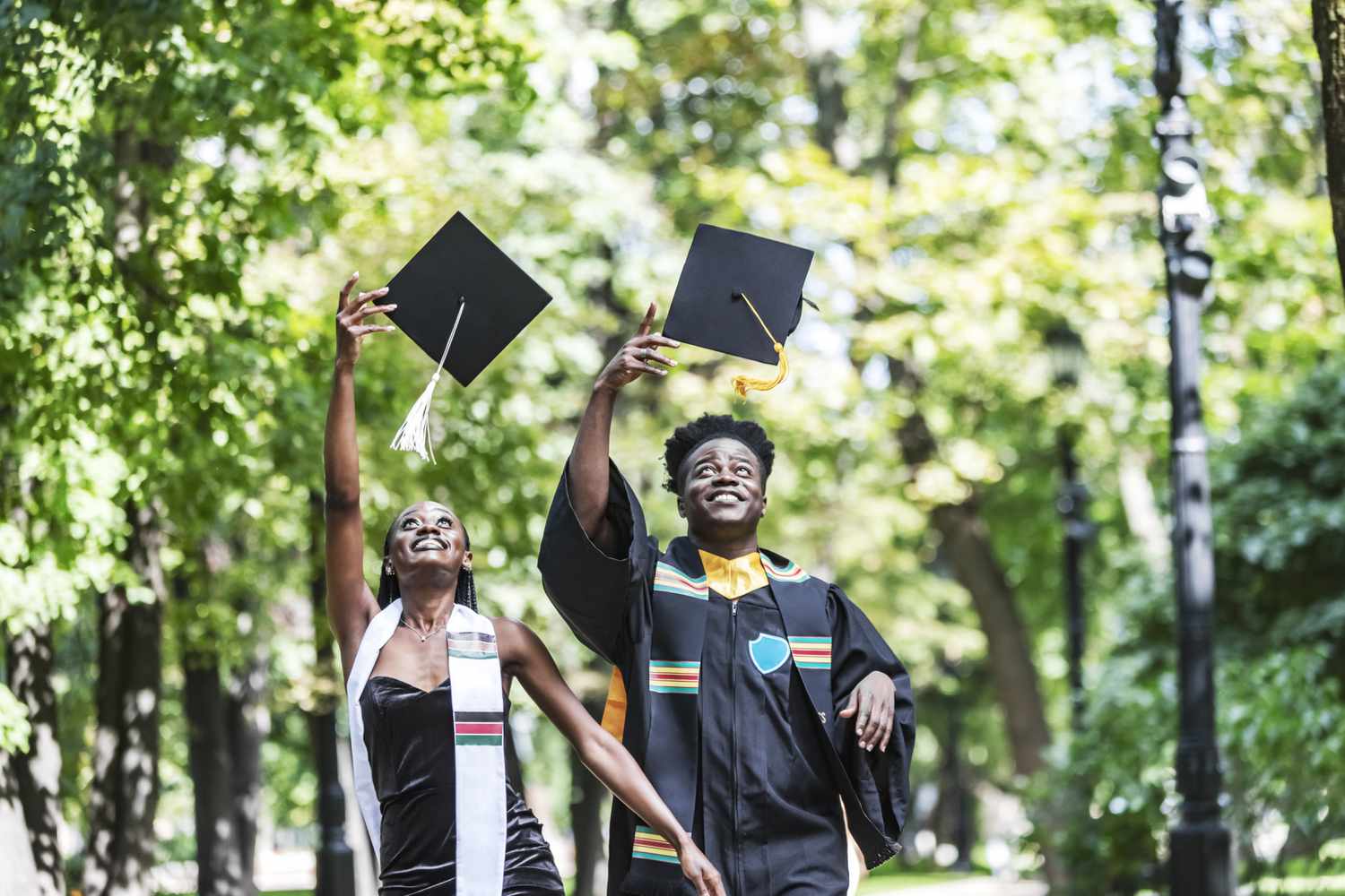 College graduates throwing caps in the air