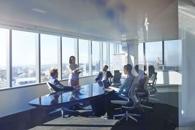 Young entrepreneur presenting project in exclusive boardroom.