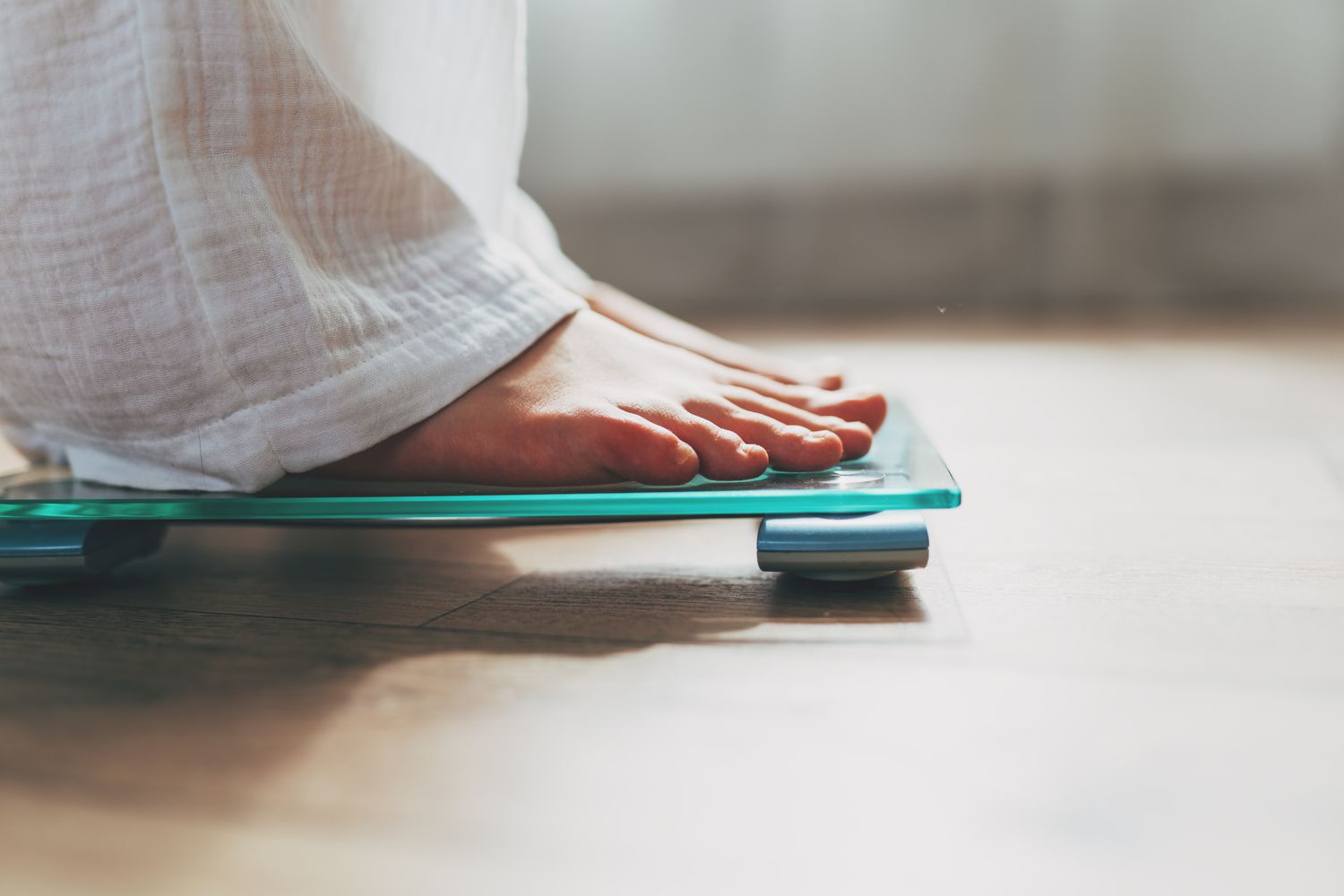 Woman standing on electronic scale.