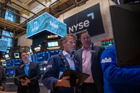 Traders work on the floor of the New York Stock Exchange (NYSE) on May 13, 2025 in New York City. 