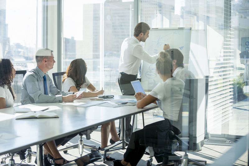 Businessman Giving a Presentation to His Team