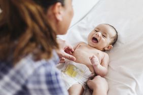 A woman tends to an infant.