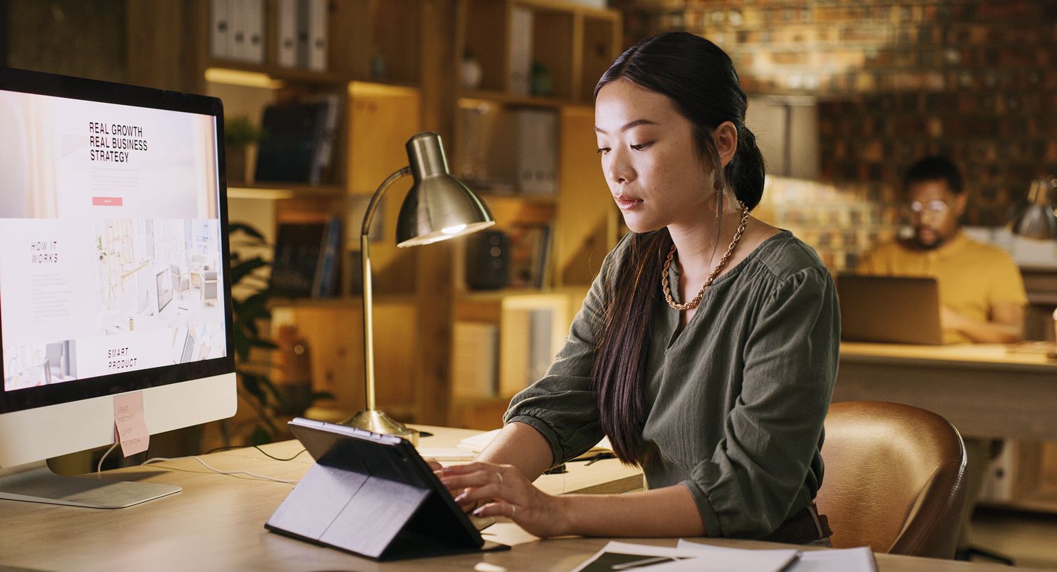 A website designer uses a tablet to comfirm the page desgin they just completed works on both PC and tablet devices.