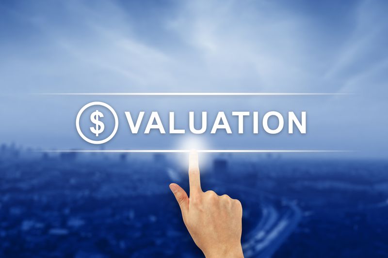 Fingers pointing to the word valuation