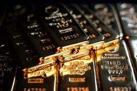 Stack of gold bullion bars with engravings